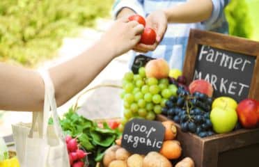 Buying apples at organic farmers market.