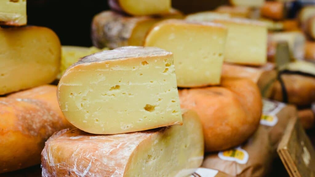 Assorted artisanal cheese wheels on display.