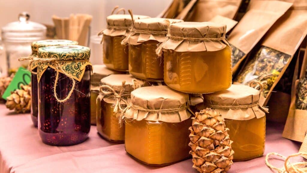 Homemade honey jars on display table.