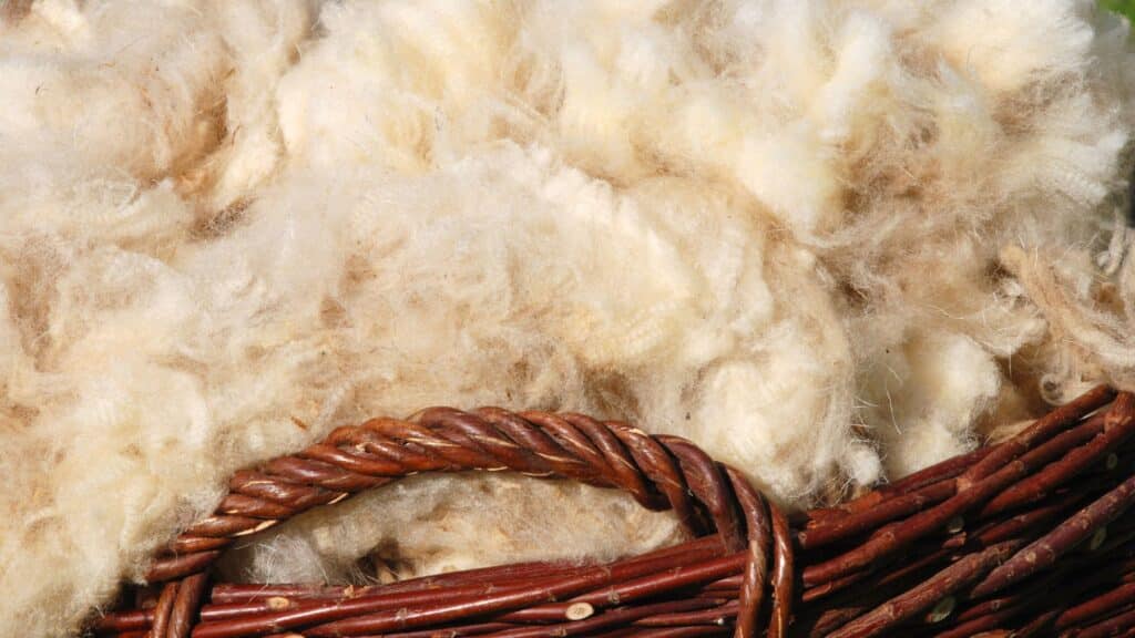 Close-up of wool in a wicker basket.